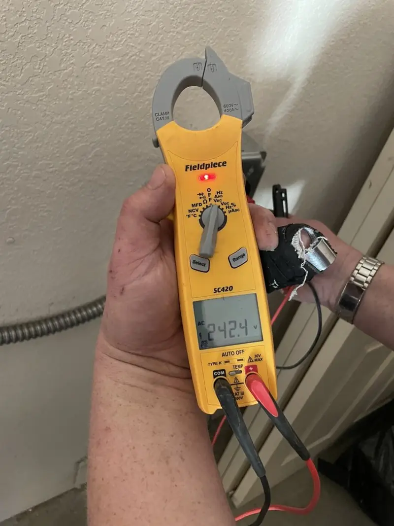 Voltage testing with clamp meter during Whole House Surge Protector in Myrtle Grove
